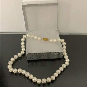 Woman’s Faux Pearls.